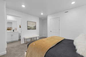Carpeted bedroom featuring recessed lighting and ensuite bathroom