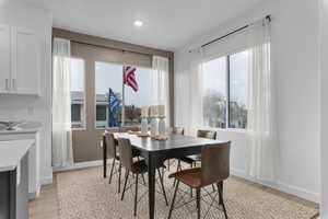 Dining space with light wood-type flooring and recessed lighting