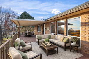 Wooden terrace featuring outdoor dining area and an outdoor living space