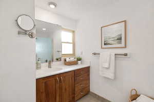 Bathroom with vanity, a shower with shower door, and light tile patterned floors