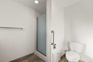 Full bath with a stall shower and tile patterned flooring