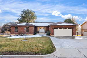 Ranch-style house featuring concrete driveway, brick siding, and a garage