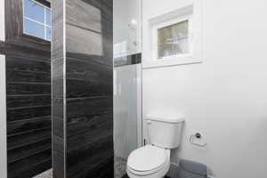 Bathroom with a stall shower and plenty of natural light