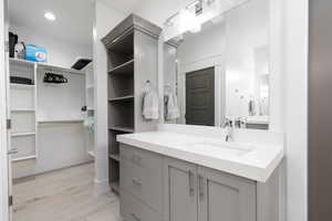 Bathroom featuring vanity, light wood-style flooring, and recessed lighting