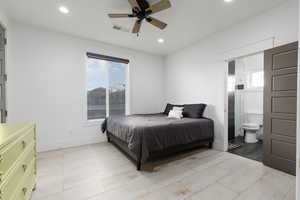 Bedroom with ceiling fan, recessed lighting, ensuite bath, and wood finish floors