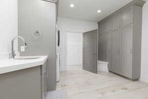 Full bathroom featuring vanity, recessed lighting, and a closet