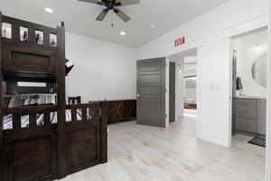 Bedroom featuring light wood-style floors, connected bathroom, recessed lighting, and ceiling fan