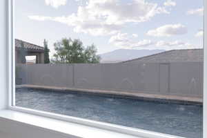 View of pool with a fenced backyard and a mountain view