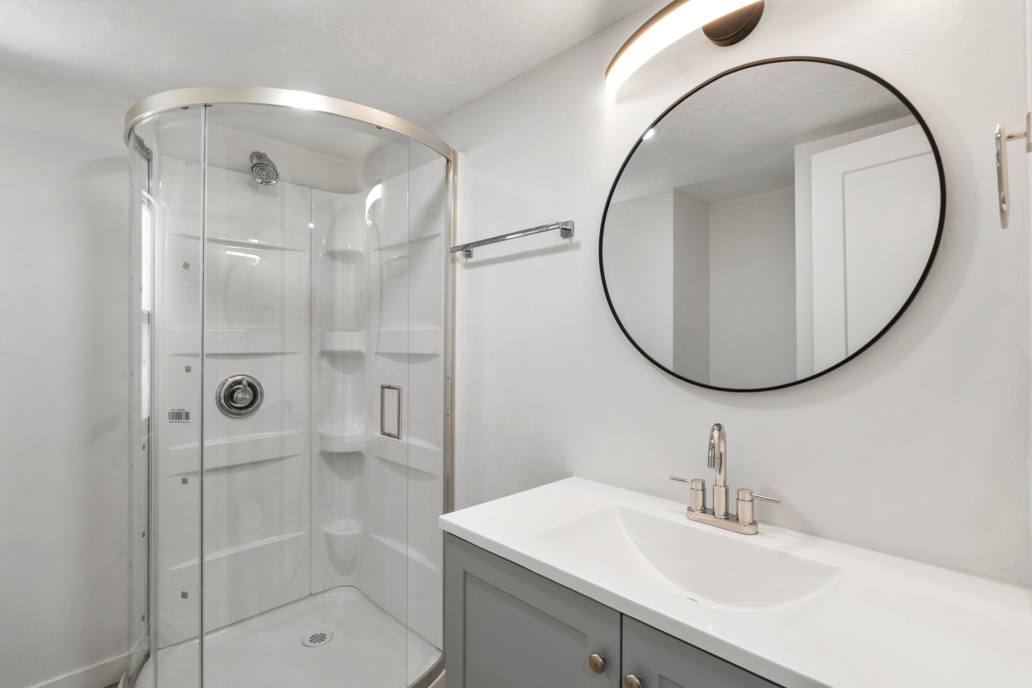 Bathroom featuring vanity and a shower stall