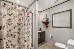 Full bathroom with a shower with curtain, vanity, and ornamental molding