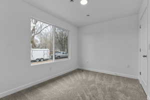 Empty room with baseboards and light carpet
