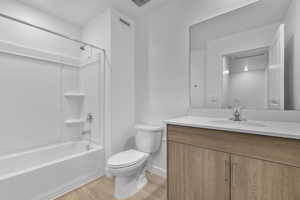 Bathroom with vanity, bathing tub / shower combination, and light wood-style flooring