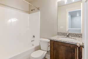 Full bathroom with shower / tub combination and vanity
