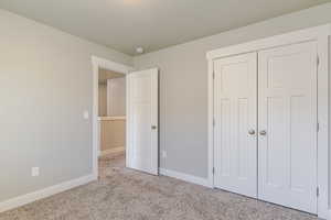 Unfurnished bedroom featuring carpet floors and a closet