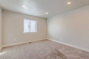 Unfurnished room featuring carpet flooring and recessed lighting