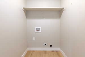 Laundry room featuring washer hookup, light wood-type flooring, and electric dryer hookup