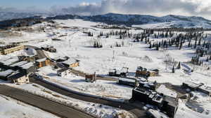 Snowy aerial view featuring a mountain view