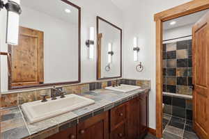 Full bath featuring large double vanity and a seperate room for toilet and bath/shower