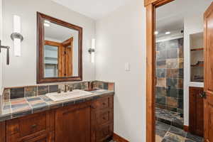 5th bedroom en suite bathroom with vanity, a stall shower