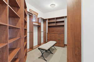 Primary bedroom suite large walk in closet with seating