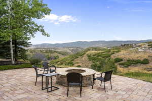 View of  terrace featuring a golf course and mountain view