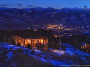 Night view of the home with the ski resort and mountain background