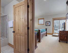Bedroom featuring access to exterior and light colored carpet