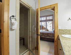 Ensuite bathroom featuring vanity and a shower stall