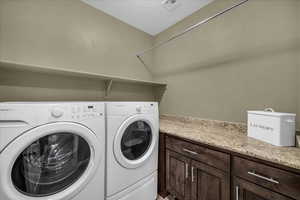 Washroom with washer and clothes dryer