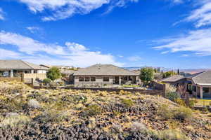 Rear view of house with a residential view, a patio, and stucco siding