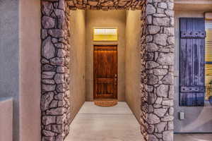 Property entrance featuring stucco siding