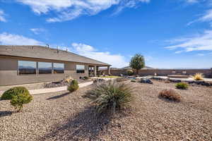 Back of property with stucco siding and a patio area