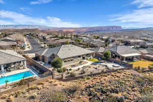 Aerial perspective of suburban area with a pool and a mountainous background