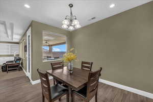 Dining area featuring light wood finished floors, a chandelier, and recessed lighting