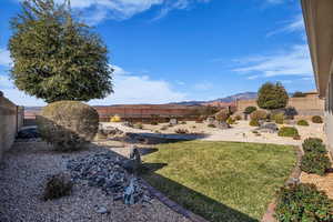Fenced backyard with a mountain view