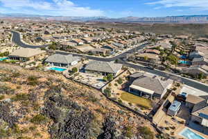 Aerial view of residential area with a pool area and mountains