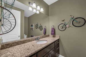 Half bathroom with toilet and vanity