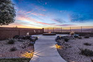 View of property's community featuring an outdoor fire pit and a fenced backyard