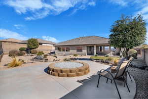 Rear view of property featuring a fenced backyard, a patio, stucco siding, and a tiled roof