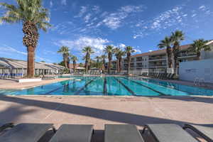 Community pool with a patio