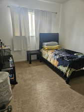 Bedroom featuring light colored carpet and baseboards