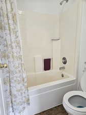 Bathroom with shower / bathtub combination with curtain