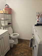 Bathroom featuring vanity and washer and clothes dryer