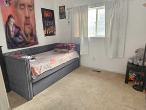Bedroom with baseboards and carpet flooring