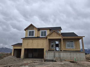 Unfinished property with a porch, roof with shingles, and a mountain view