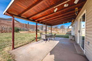 Fenced backyard with outdoor dining area and a patio area