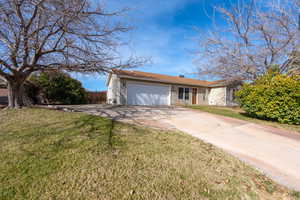 Ranch-style house with driveway and an attached garage