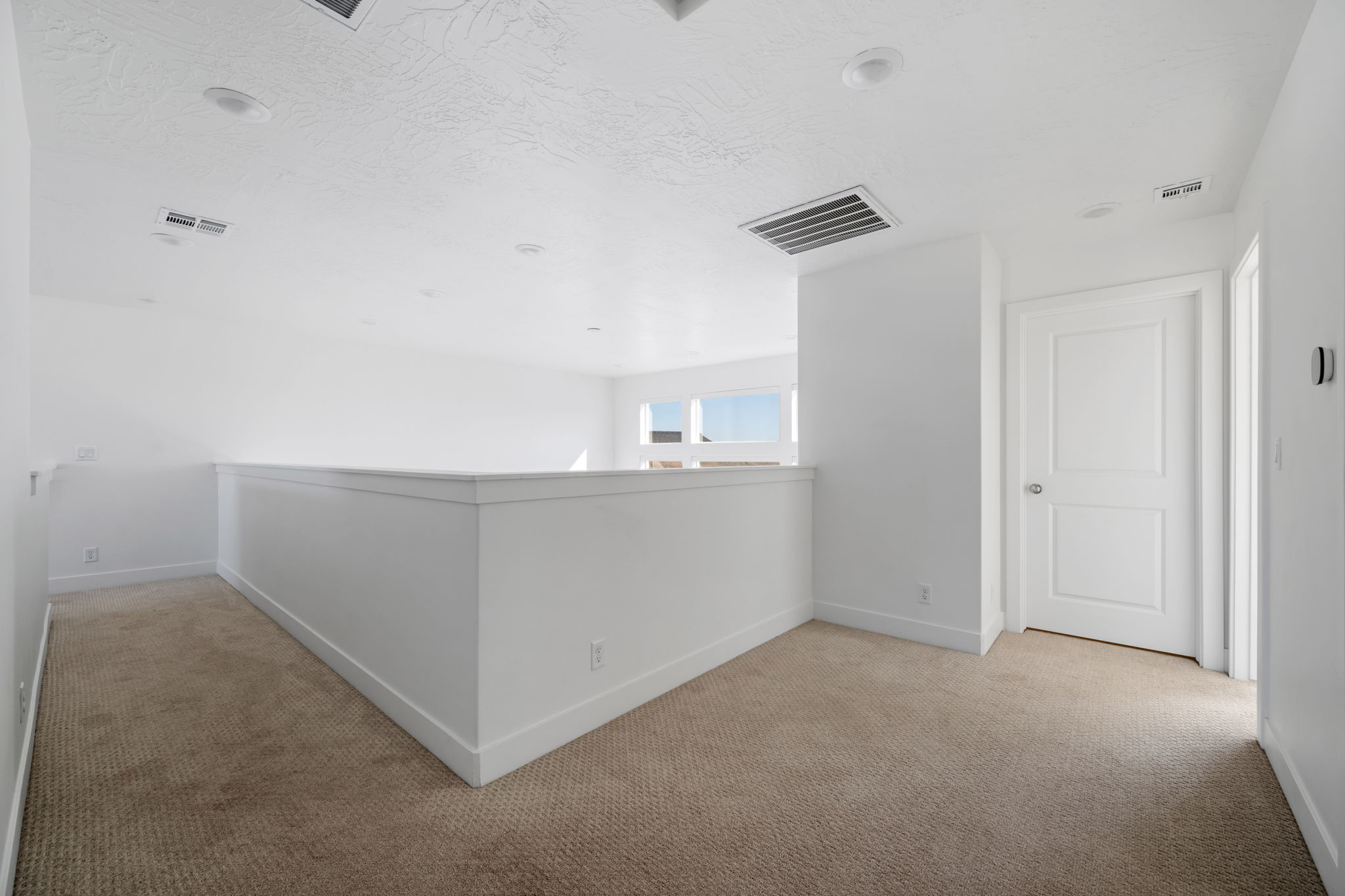 Corridor with baseboards and light carpet