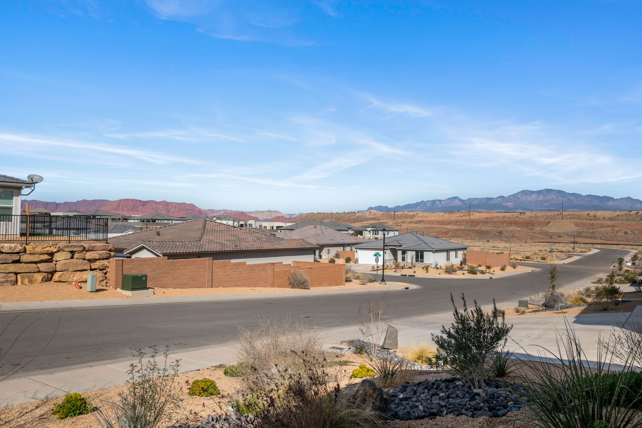 View of mountain backdrop featuring nearby suburban area