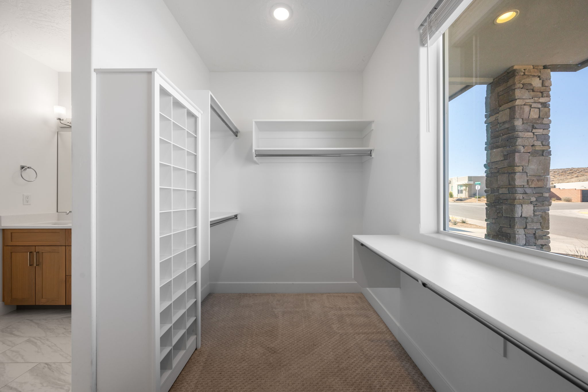 Walk in closet featuring light carpet